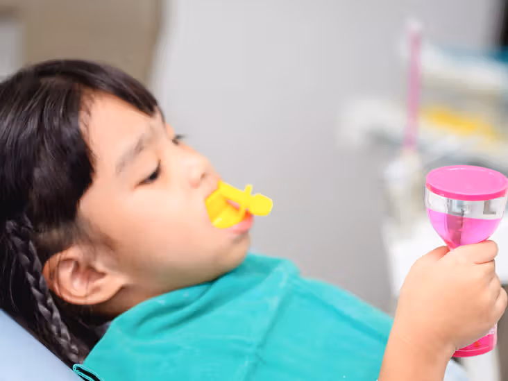 fluoride varnish, pediatric dentist in Junagadh, children dental clinic Junagadh, kids dentist in Junagadh, fluoride treatment for kids, cavity prevention, dental care for children, enamel protection, fluoride for children, tooth decay prevention, fluoride benefits, Parshvi Dental Care, dental clinic in Junagadh, best pediatric dental care, kids oral health, fluoride application, children’s dental treatment, dental clinic for kids, early cavity treatment, enamel strengthening